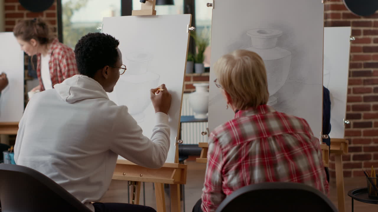 African american man helping senior student in art classroom