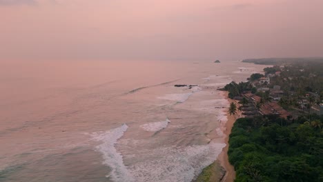 stunning aerial footage capturing the breathtaking weligama coastline bathed in the warm, golden hues of sunset.