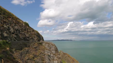 People-hiking-on-trail-along-the-coast-on-a-sunny-day