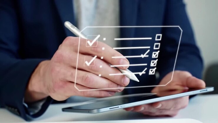 Businessman Completing a Digital Checklist on a Tablet with a Stylus