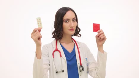 female doctor holding pills and contraception on white background