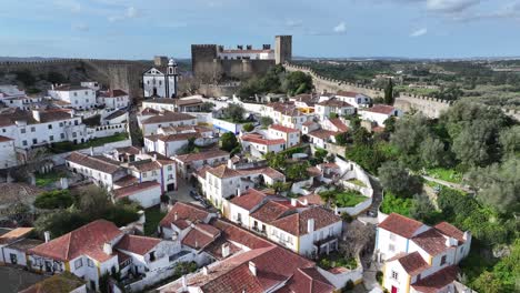 obidos skyline at obidos in district of leiria portugal. historic city scenery. medieval architecture. walls of castle construction. obidos skyline at district of leiria portugal. old village
