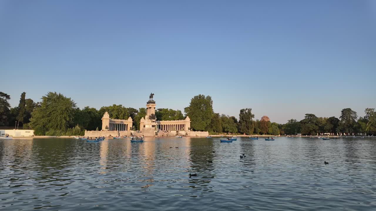 The Lake of El Retiro Park in Madrid, Spain. Time lapse at the golden hour with some boats and ducks. Sunny summer afternoon. 4K