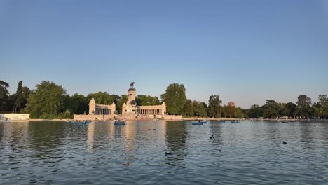 The Lake of El Retiro Park in Madrid, Spain. Time lapse at the golden hour with some boats and ducks. Sunny summer afternoon. 4K