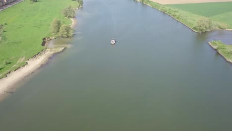 aerial footage of the boat passing on the big river or canal in holland