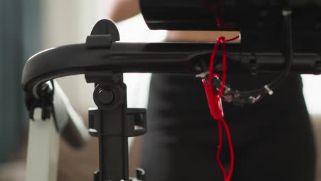 woman runs on treadmill taking water bottle closeup. dynamic sporty lady drinks water during training process at home slow motion. domestic fitness area