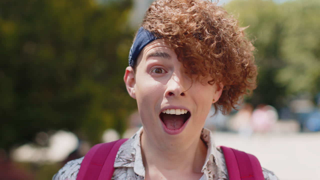 Happy man taking off sunglasses looking surprised at camera with big open eyes shocked by victory