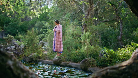 mysterious girl looking lake water covered waterlilies standing forest landscape