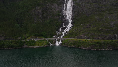 Impressive-Langfoss-waterfall-cascades-down-cliffside-toward-Akrafjord,-Norway