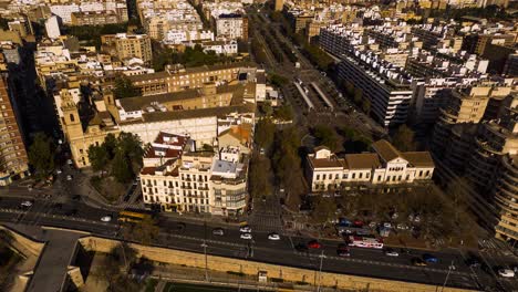 this hyperlapse shows the main highway thats running down the side of the very green central park of valencia , with a tram turning circle in shot