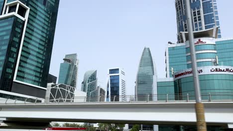 a vehicle passes by dubai's modern skyline