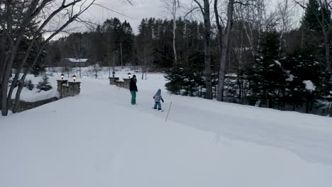 drone following kid learning how to snowboard in the snow