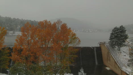 Yellow-tree-downtown-Evergreen-Lake-house-foggy-Colorado-historic-downtown-aerial-drone-blizzard-fall-autumn-winter-first-snowfall-foggy-Rocky-Mountain-front-range-Denver-right-slowly-motion-reveal