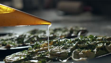 chef pouring sauce on vegetarian pizza