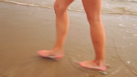 woman walking along the tide