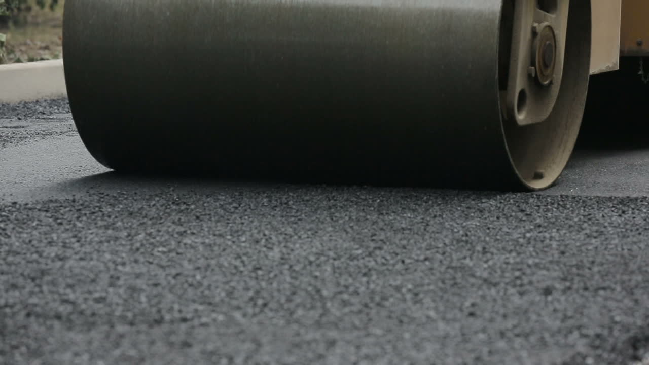 Laying Asphalt With Road Construction. Road rollers building the new asphalt road