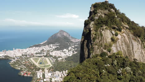 camera flying up the corcovado hill in rio de janeiro unveiling the statue of christ the redeemer