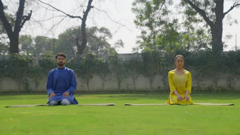 indian couple doing diamond yoga pose