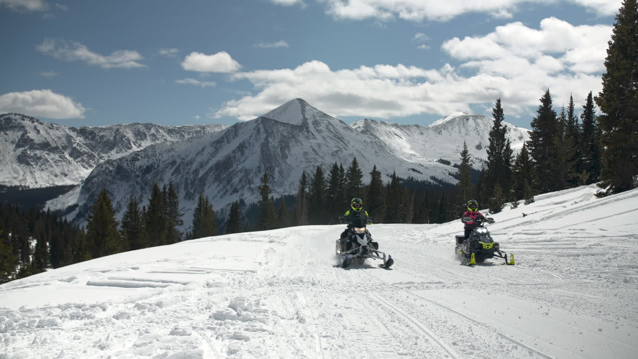 snowmobiling slow motion in mountain scenery