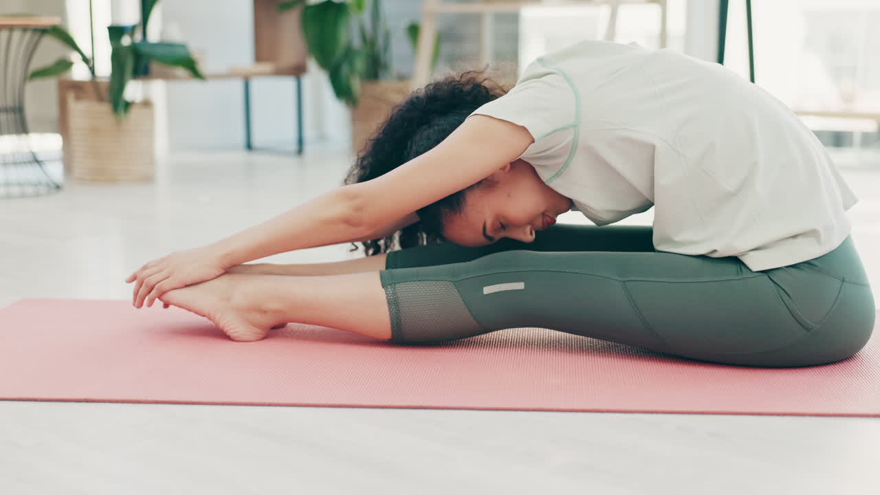 Woman stretching legs on floor for home workout