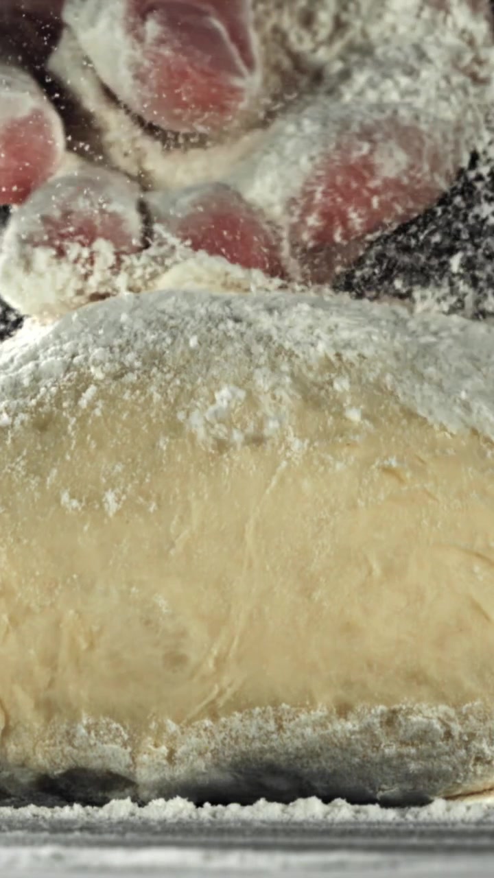 Slow Motion Close-up of Flour Falling on Dough