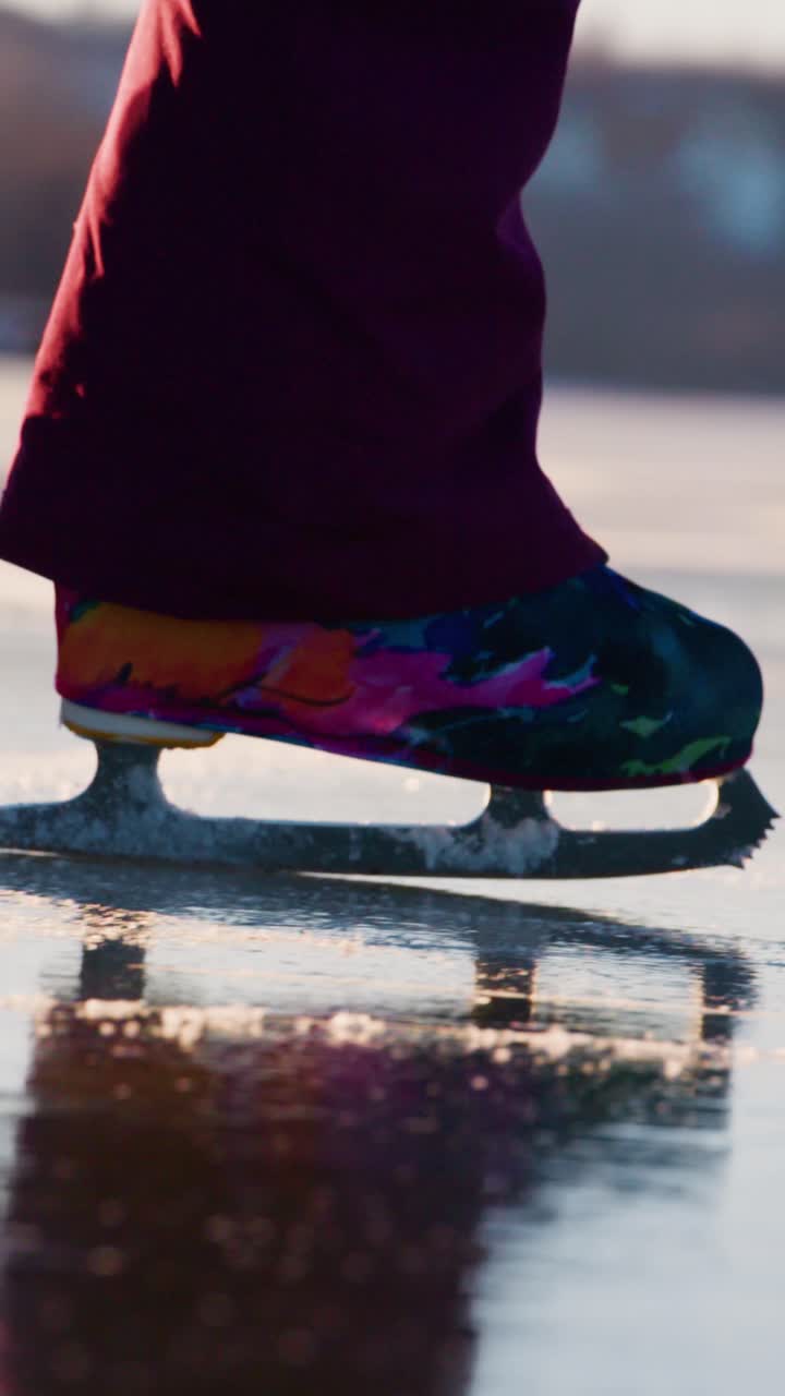 A Close-Up of a Colorful Ice Skate Gliding Over a Glimmering Ice Surface, Highlighting Motion and Reflection in a Dynamic Winter Sports Scene