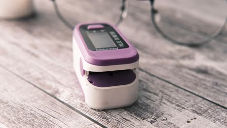 finger pulse oximeter on wooden table