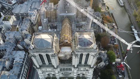 Drone-with-camera-movement-rising-on-top-of-the-towers-of-the-Notre-Dame-church-in-Paris,-renovation