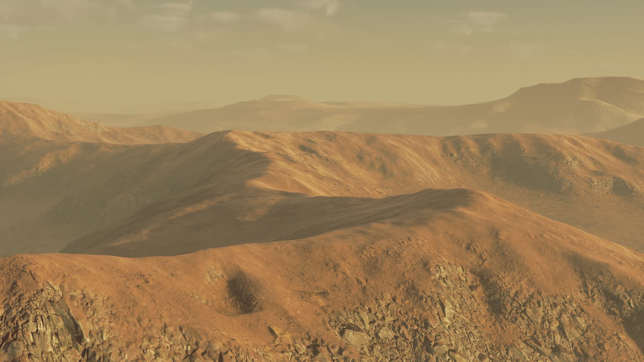 Vast desert landscape featuring rugged mountains under golden sunlight