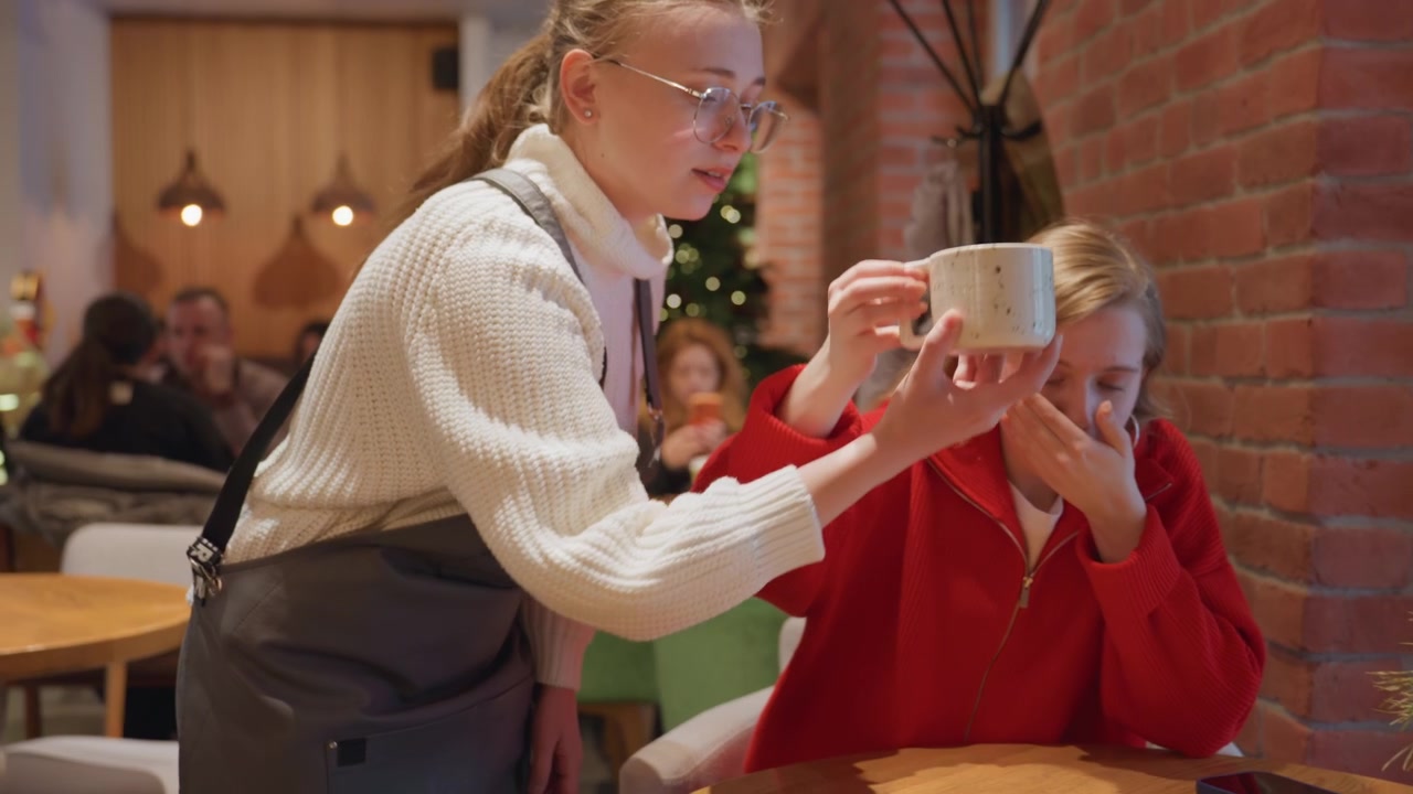 Friendly Waitress Serves Coffee to Customer in Cozy Cafe