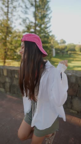 woman in pink hat and white shirt