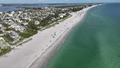 aerial flying backward away from holmes beach and up the coastline to anna maria, ami, florida