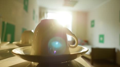 coffee cup on a table in a room with sunlight