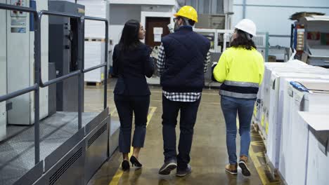 Back-view-of-project-manager-showing-factory-to-technicians