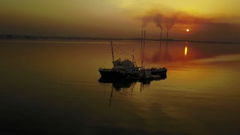 cinematic clips of an abandoned harbor at sunset where birds turned most of the remaining rusty boats into their own nests-“islands”.
