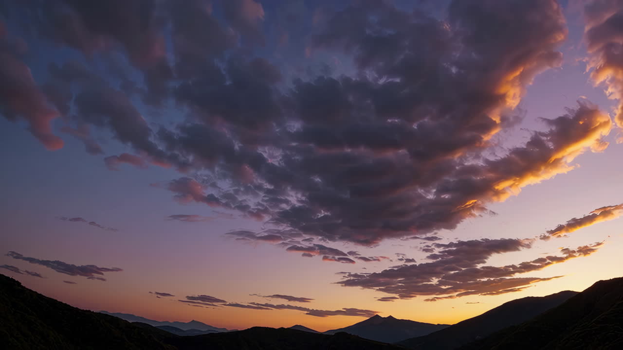 Sunset over Mountain Range with Dramatic Cloudscape