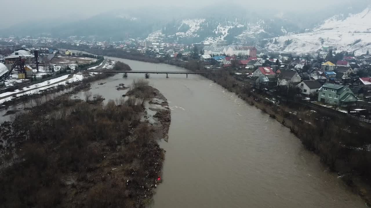 A chemical industry that pollutes a mountain river. The global problem of environmental pollution.