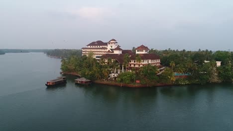 Drone-footage-of-a-wooden-boat-docking-at-the-luxurious-hotel