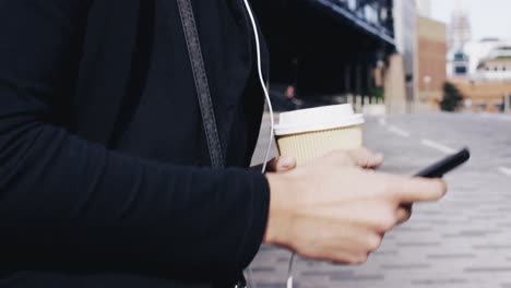 attractive business woman commuter using smartphone walking in city of london