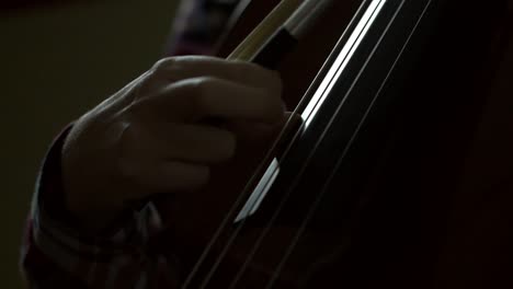 hand plucking cello strings