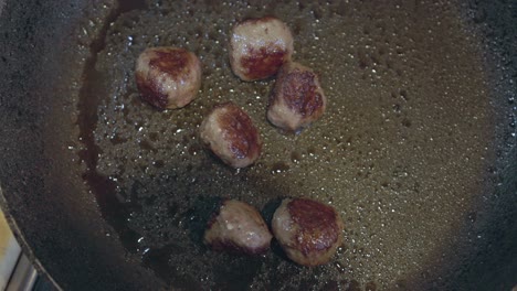 Overhead-shot-of-a-batch-oof-meatballs-frying-in-a-frying-pan