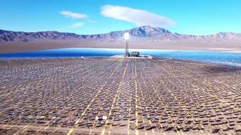 aerial of solar farm with vfx 3d graphics in the desert, sun reflecting off tower, renewable technology