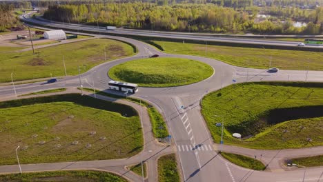 traffic roundabout route near residential district of katlakalns in latvia. aerial drone shot