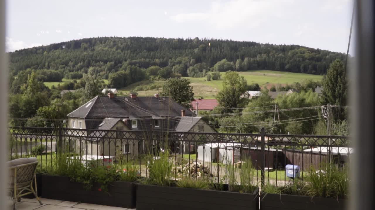 View from the window with green hills cottage moutains in summer in slow motion
