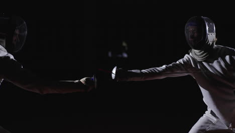 two fencers in a competition