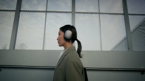 woman walking on stairs with headphones