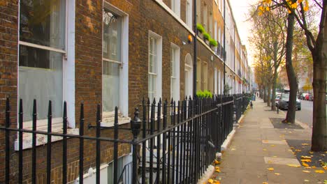 close up of decorative pointed wrought iron fence in front of victorian terrace houses in bloomsbury, london