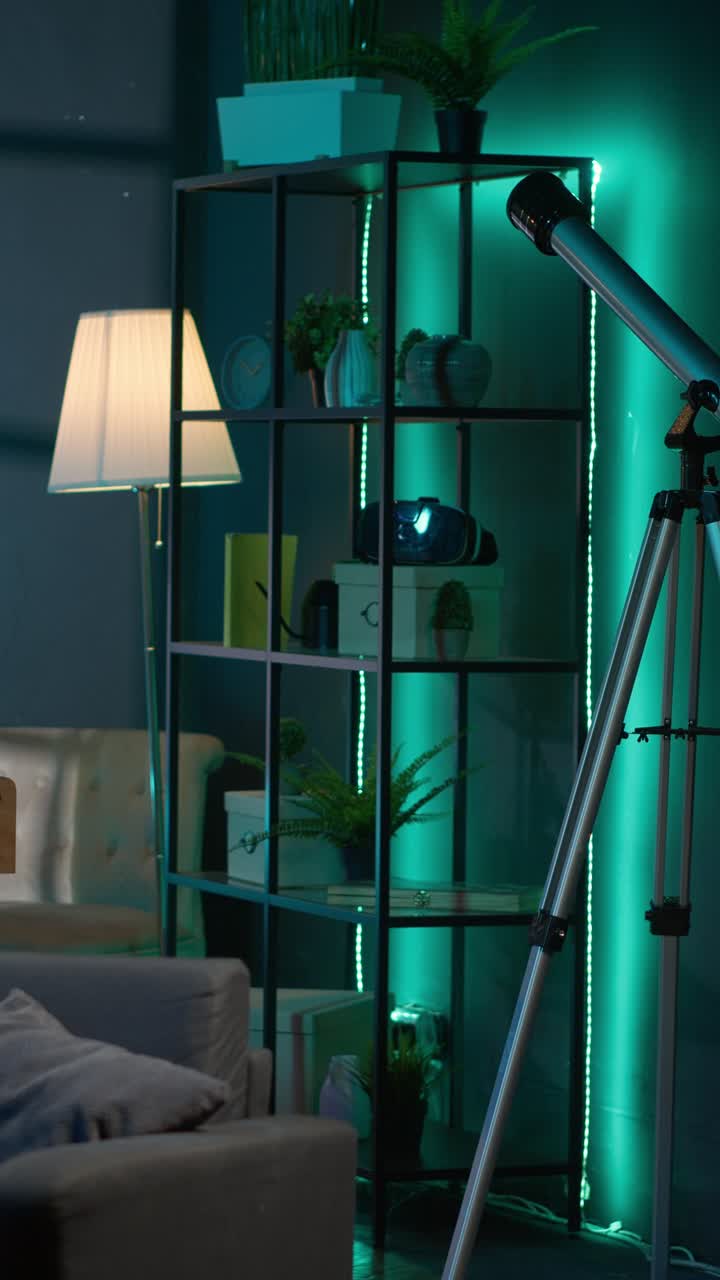 Empty Living Room with Foosball Table and Telescope at Night