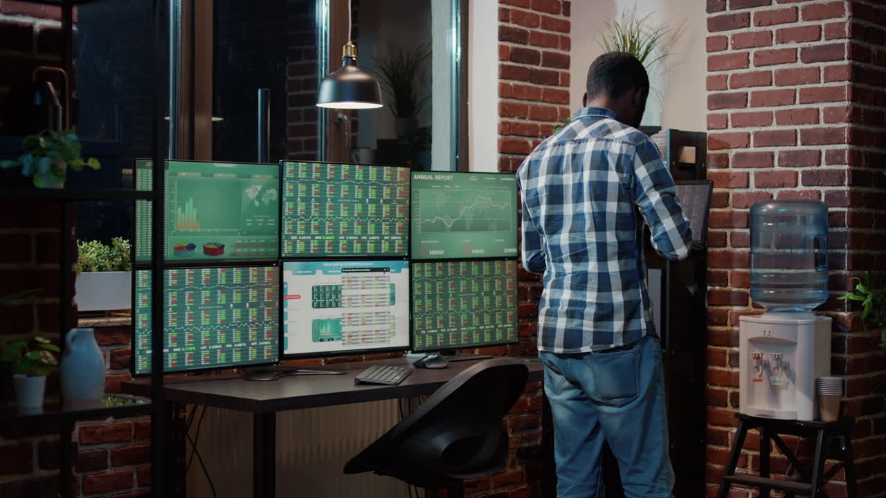 Hedge fund trader looking at real time stocks numbers on laptop