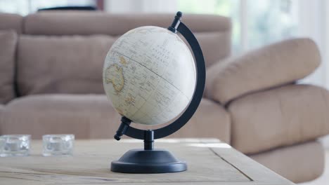 rotation around a terrestrial globe placed on a living room table